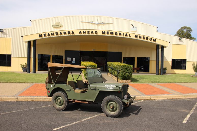An old army vehicle is parked outside the Meandarra ANZAC Memorial Museum